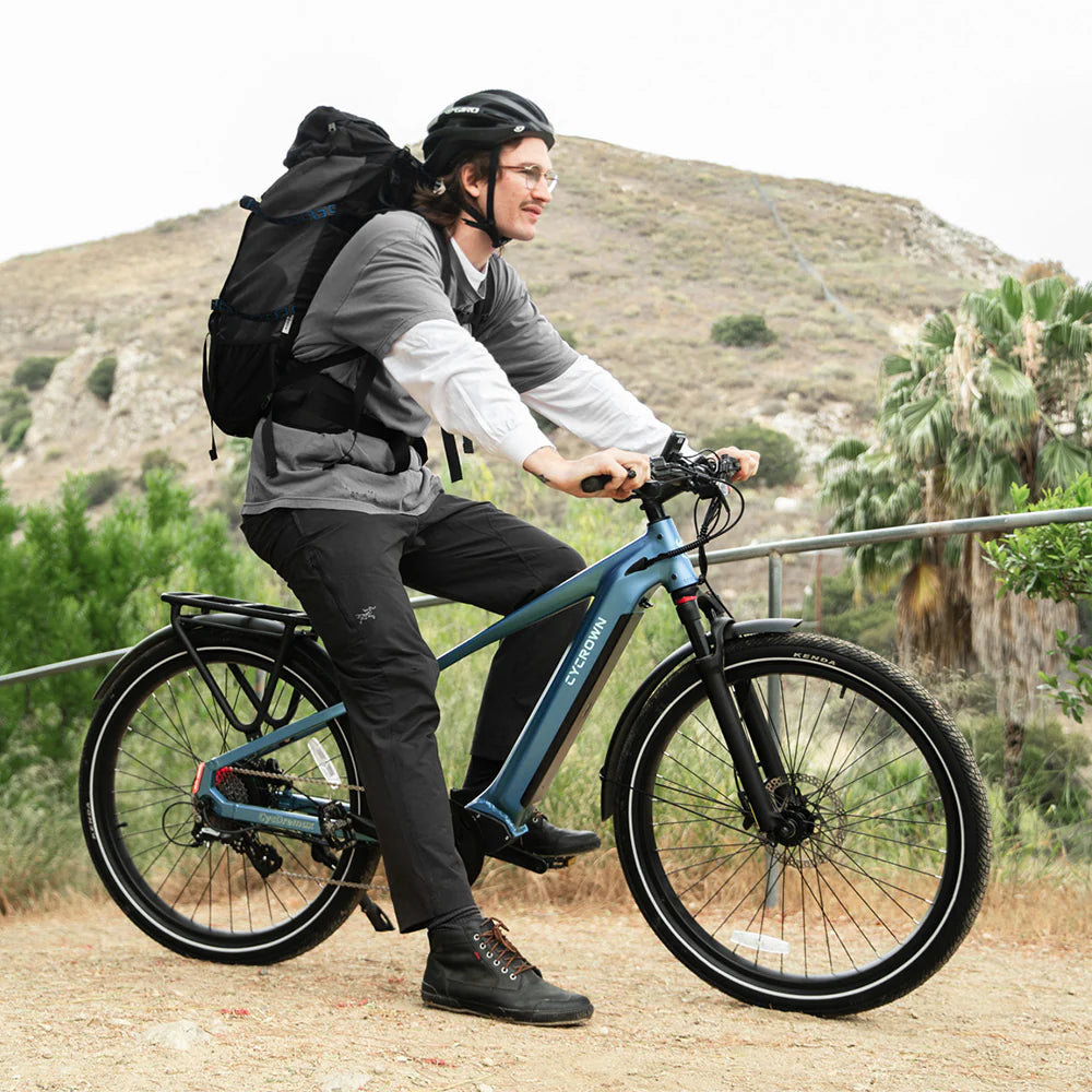 Blue Cycrown DREMAX high-step electric bike with a rider outdoors